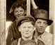 A group portrait of men and boys at a construction site. A group portrait of men and boys at a construction site.