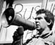 Photograph of speakers at a demonstration.