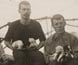 Photograph of explorers aboard ship with sled dogs and puppies.