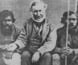 Photograph of Angus McMillan sitting with two Aboriginal men.