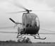 Photograph of a helicopter spraying chemicals on a crop.