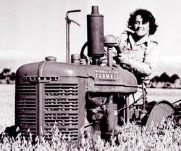 Photograph of a woman driving a tractor during World War II. Photograph of a woman driving a tractor during World War II.